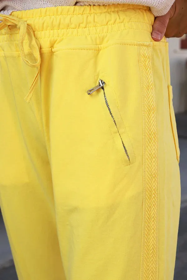 Yellow cotton jogging bottoms with embroidered cheveron outseams